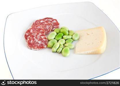 dish with fava beans and salami slices