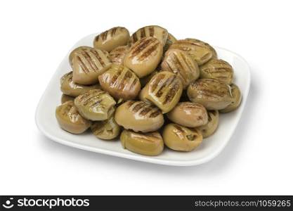 Dish with grilled green olives as a snack isolated on white background