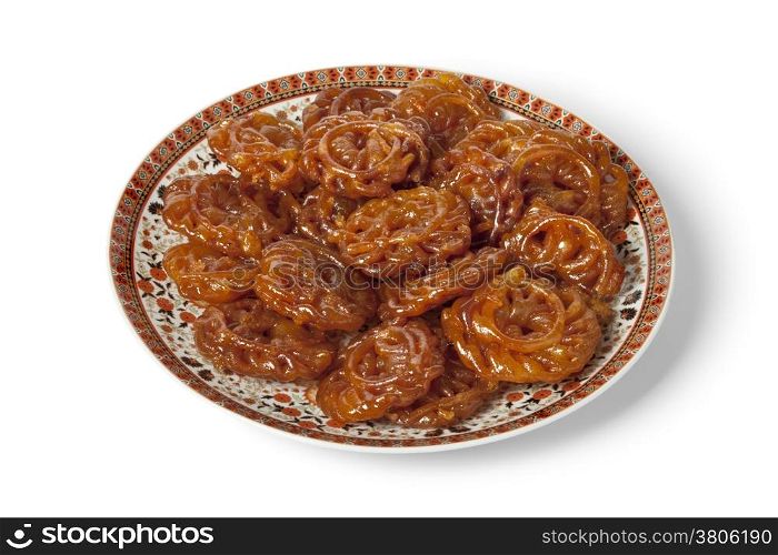 Dish with Moroccan chebakia made for ramadan on white background