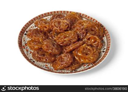 Dish with Moroccan chebakia made for ramadan on white background