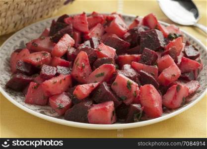 Dish with Moroccan salad with beets and potatoes close up