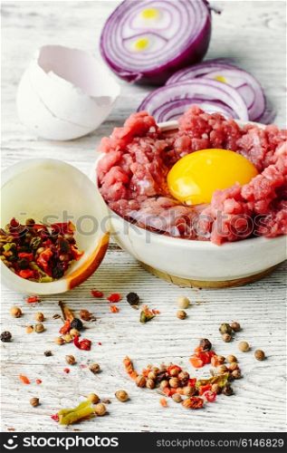 dish with raw minced beef with egg yolk and spice. Raw minced beef