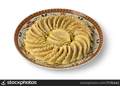 Dish with traditional festive Gazelle Horns cookies isolated on white background