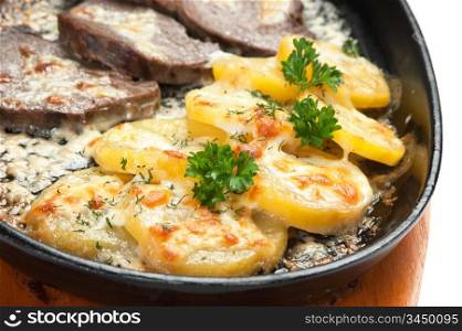 dishes of roast meat with potato and spices