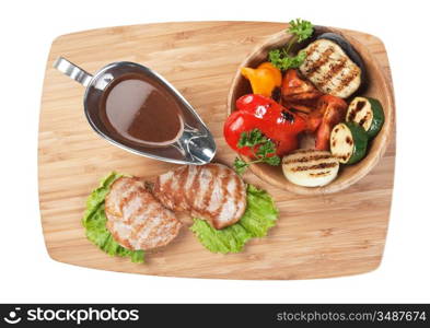 dishes of roast meat with vegetables and spices isolated on white background