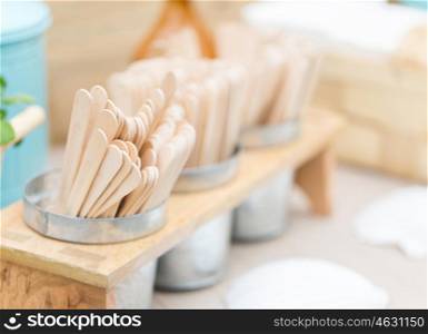 dishware and eating concept - close up of wooden ice cream sticks on restaurant table. close up of wooden sticks on restaurant table