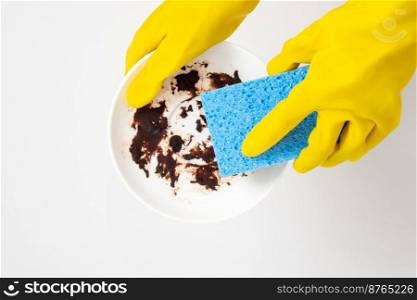Dishwashing concept, Hands in rubber gloves to holding light blue sponge and wash of dirty dishes.