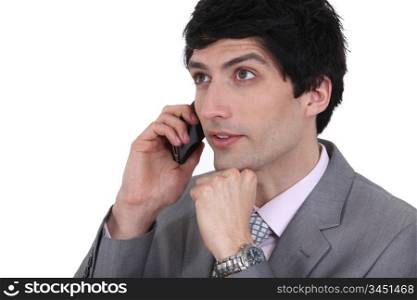 dishy businessman on phone with dreamy eyes