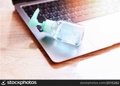 Disinfects the surface of the laptop by sanitizer spray or alcohol gel washing hand hygiene on the working place for quarantine coronavirus covid-19 working from home concept.