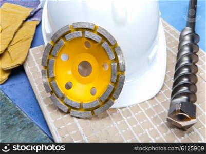 disks for concrete, drill and a helmet on a tile