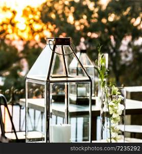Display candles and glass lanterns for outdoor decor at corporate event or gala dinner