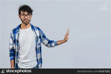Displeased young man rejecting with rejection gesture, throw palms isolated. Displeased person with rejection gesture isolated, pulls palms in rejection, frowns in disgust