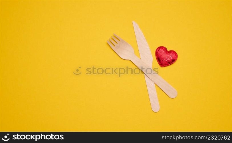 disposable fork and knife on a yellow background, eco utensils. Zero Waste