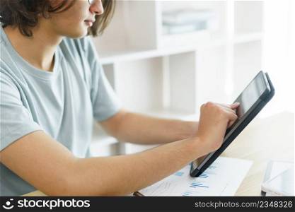 Distance education concept, Teen boy checking schedule class and studying online on tablet at home.