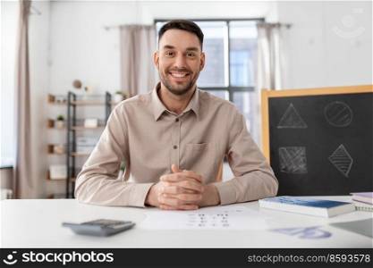 distance education, school and remote job concept - happy smiling male teacher having online class at home office. teacher having online class at home office
