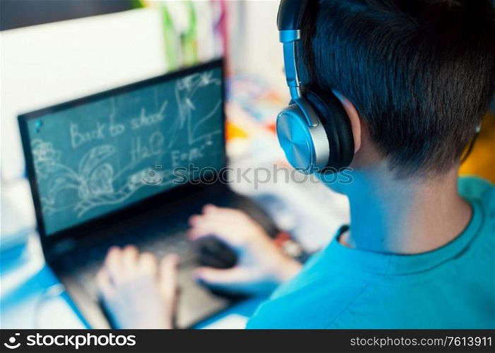 Distance learning or online education conference concept. Schoolboy studies at home and does school homework by laptop. Distance learning or online education concept