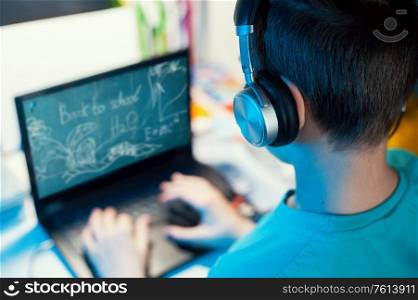 Distance learning or online education conference concept. Schoolboy studies at home and does school homework by laptop. Distance learning or online education concept