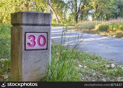 distance marker on Boyd Lake bike trail in northern Colorado, summer morning scenery