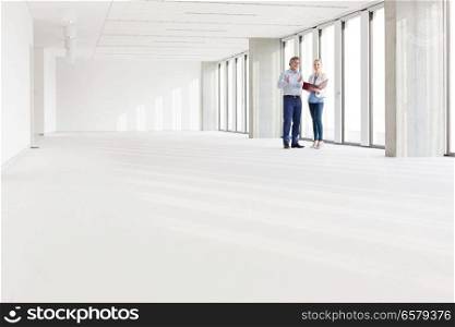 Distant image of business people discussing in empty office