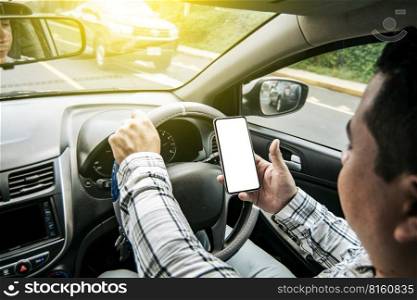 Distracted driver using the cell phone while driving, Man using his phone while driving, Person holding the cell phone and with the other hand the steering wheel, Concept of irresponsible driving