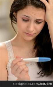 Distraught girl waiting for pregnancy test result thinking about future
