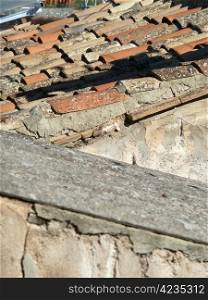 distressed old terracotta tiles on a roof