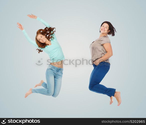 diverse, body positive and people concept - happy different age and size women jumping over blue background. happy different women jumping over blue