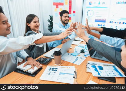 Diverse business team celebrate successful meeting with high-fives and expressions of happiness in corporate office meeting represent unity success and professional integrity. Concord. Diverse business team celebrate successful meeting with high-fives. Concord