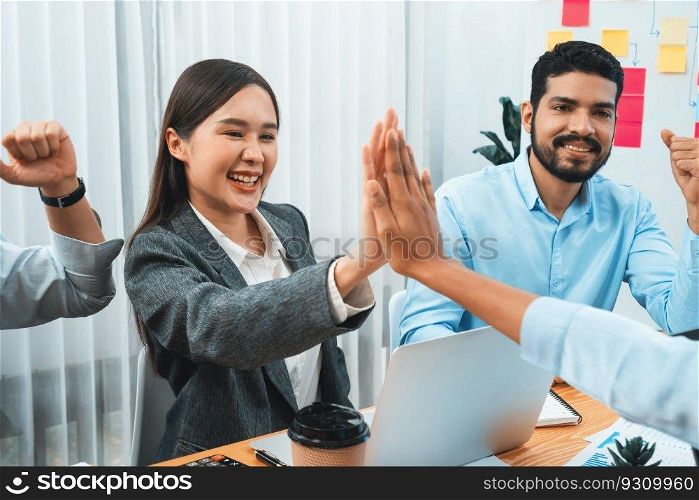 Diverse business team celebrate successful meeting with high-fives and expressions of happiness in corporate office meeting represent unity success and professional integrity. Concord. Diverse business team celebrate successful meeting with high-fives. Concord