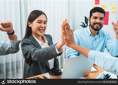 Diverse business team celebrate successful meeting with high-fives and expressions of happiness in corporate office meeting represent unity success and professional integrity. Concord. Diverse business team celebrate successful meeting with high-fives. Concord