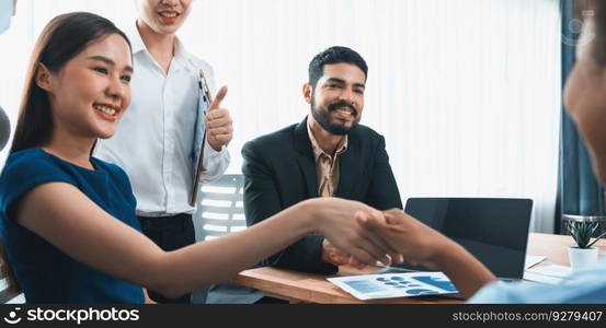 Diverse coworkers celebrate success with handshake and teamwork in corporate workplace. Multicultural team of happy professionals united in solidarity by handshaking in office. Concord. Diverse coworkers celebrate success with handshake. Concord