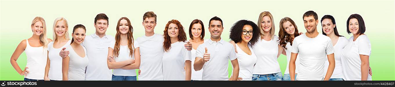 diverse, gesture and people concept - group of happy different body size and age and gender people in white t-shirts hugging showing thumbs up over green natural background