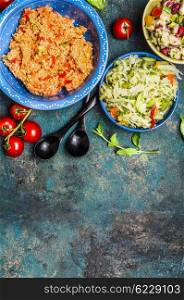 Diverse salads bowls on rustic background, top view