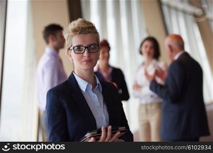 diverse startup business people group standing together as team in modern bright office interior with blonde woman with glasses in front as leader