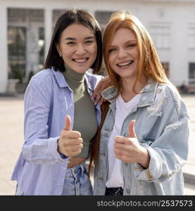 diverse women posing outside