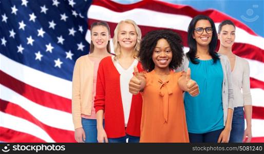 diversity and people concept - international group of happy smiling different women howing thumbs up over american flag background. international american women showing thumbs up