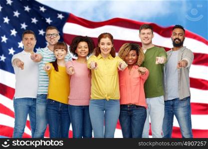 diversity, choice, ethnicity and people concept - international group of happy smiling men and women pointing finger on you over american flag background. international group of people pointing on you