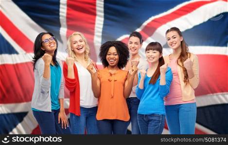 diversity, ethnicity and people concept - international group of happy smiling different women celebrating success over british flag background. international happy women over british flag