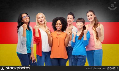 diversity, ethnicity and people concept - international group of happy smiling different women celebrating success over german flag background. international happy women over german flag