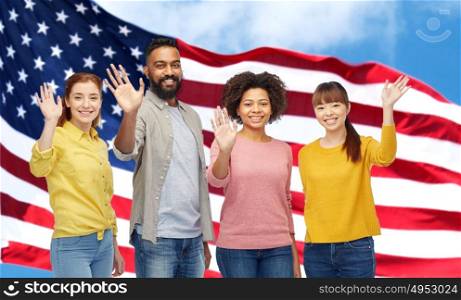 diversity, immigration and people concept - international group of happy smiling men and women waving hands over american flag background. international group of happy people waving hands