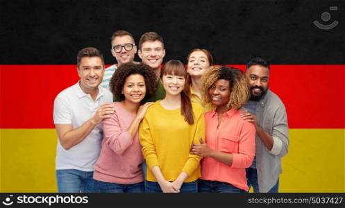 diversity, immigration, friendship and people concept - international group of happy smiling men and women over german flag background. international group of happy smiling people