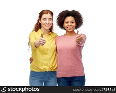 diversity, international, ethnicity, friendship and people concept - happy smiling women showing thumbs up and hugging over white