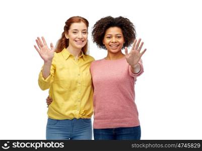 diversity, international, friendsip, ethnicity and people concept - happy smiling women waving hands over white