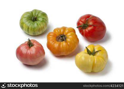 Diversity of beefheart tomatoes on white background