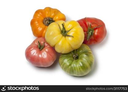 Diversity of whole Beefsteak Tomatoes on white background