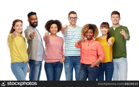 diversity, race, ethnicity and people concept - international group of happy smiling men and women pointing finger on you over white