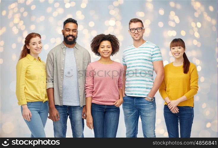 diversity, race, ethnicity and people concept - international group of happy smiling men and women over holidays lights background