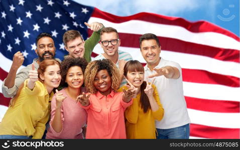 diversity, race, ethnicity and people concept - international group of happy smiling men and women showing thumbs up and peace over american flag background