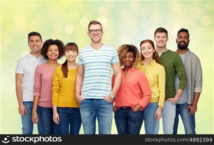 diversity, race, ethnicity and people concept - international group of happy smiling men and women over summer green lights background