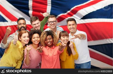diversity, race, ethnicity and people concept - international group of happy smiling men and women showing thumbs up and peace over british or english flag background